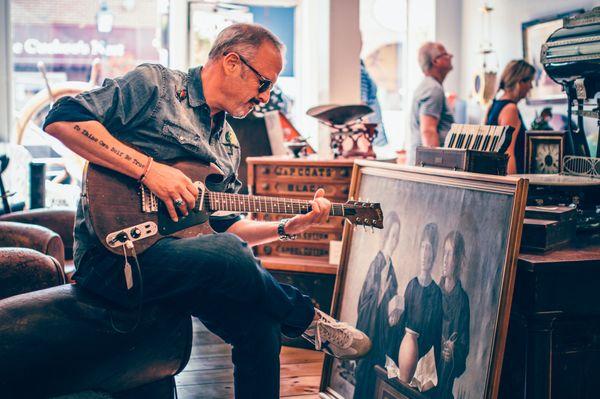 Father plays a vintage guitar.