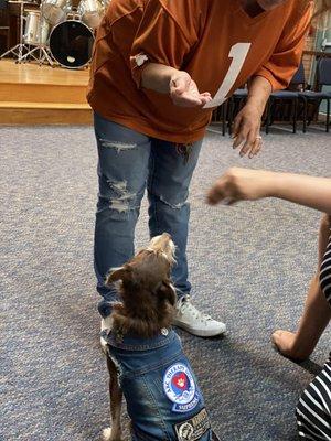 Residents with therapy dog at chapel.