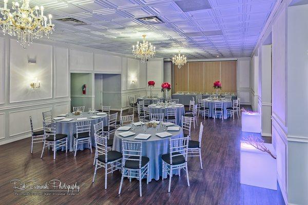 The Amanda room: Hardwood floors, neutral walls, and a touch of old world brick. The room can accommodate 165 people for a sit-down dinner