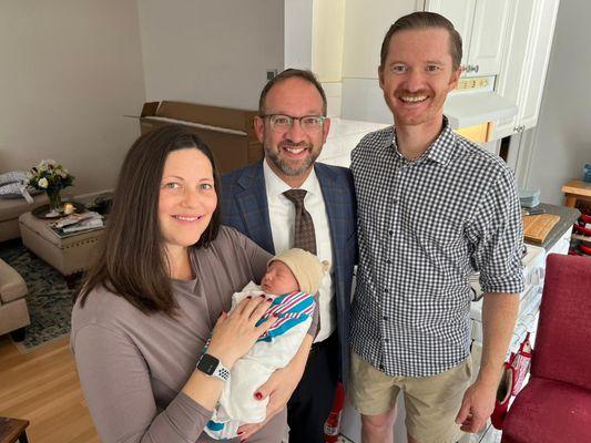 Mom, Dad and newly circumcised baby with Rabbi Asher