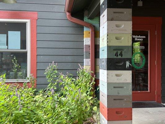 Side door with bee garden and bee  hive pillars. So fun