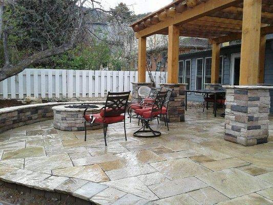 Custom Flagstone Patio with Pergola/Stone Veneer Columns, Gas Firepit, & Seat Wall.