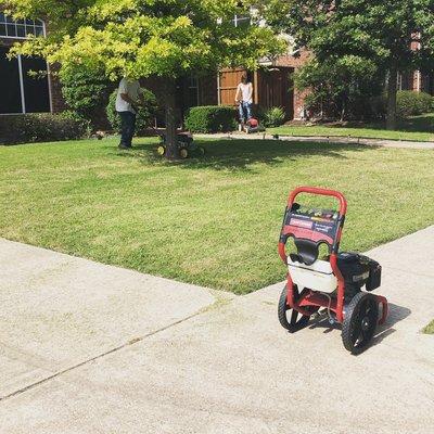 Power washer driveway and sidewalk as well a nice yard cut