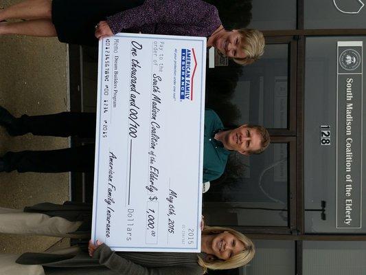 South Madison Coalition of the Elderly receiving a donation from the Agency