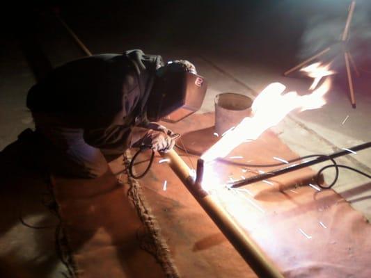 Nighttime welding on rooftop gas piping