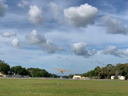 Plane landing at the Spruce Creek Fly In private airport