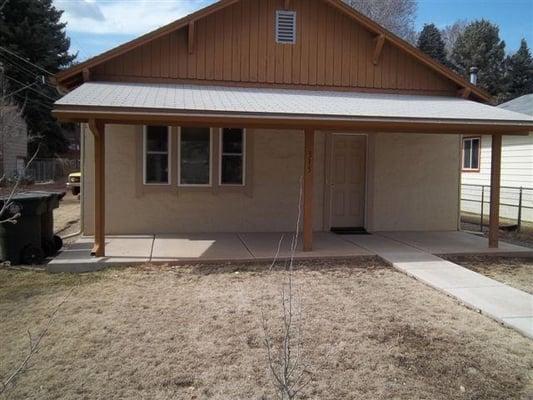 Exterior elevation shows new windows and door.