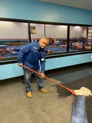 Waxing of VCT floor in progress. First coat of wax going down.