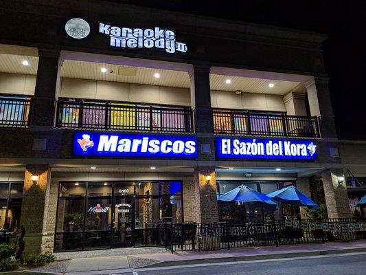 Storefronts for Karaoke Melody II and Mariscos El Sazon del Kora.