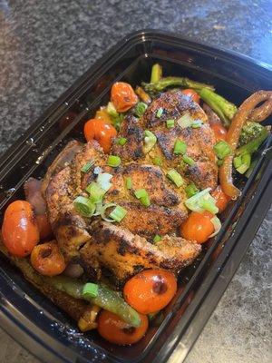 Grilled chicken cutlet over a bed of fall veggies and black sauce