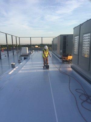 Finishing the membrane installation by hot-air welding all lap seams together leaving a complete monolithic membrane covering.