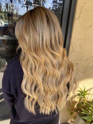 Blonde "lived-in" highlights with sewn in hair extensions for length and volume.