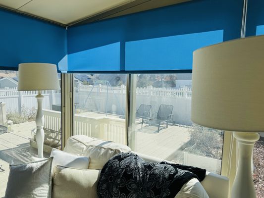 Light filtering blue roller shades.