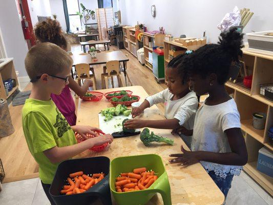 Preparing vegetable platters for a classroom event.