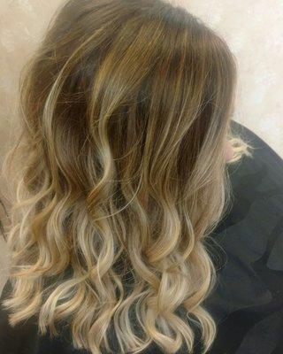 Base color and balayage finished with loose waves