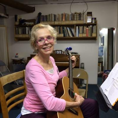 Elizebeth at the guitar singing folk songs