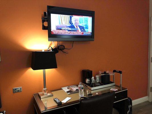 The tv and desk. Look at those wires- isn't that a code violation of something?