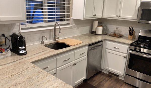 Our finished kitchen remodel with beautiful stainless steel under-mount sink, built-in cutting board, & Astoria granite from Elemar