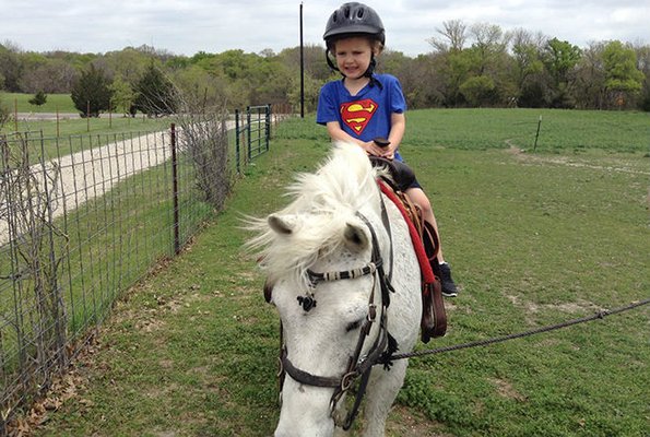 Superman on a pony ride