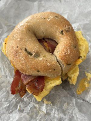 Bacon egg and cheese on a green chile bagel.