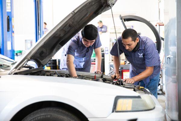 Automotive Technician students working in lab.