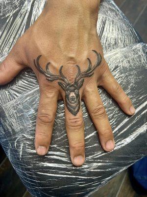 Deer hand tattoo by Ed.