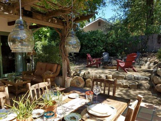 Al fresco dining space and fire pit.