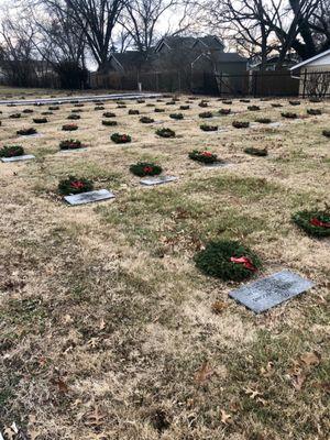 Look at all the beautiful wreaths laying on a fallen vet. 2019