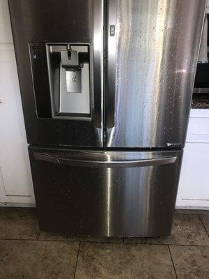 Stainless steel fridge before cleaning