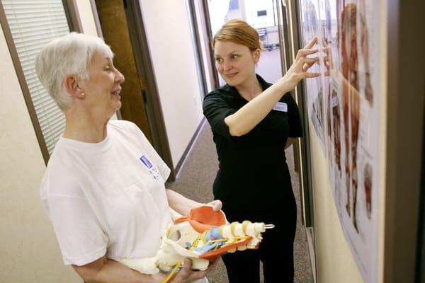 Physical Therapist Meg Gogin helps educate a patient at our clinic