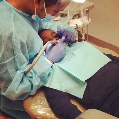 My brave trooper getting his teeth cleaned by dr. Trac's dental assistant. He really takes his time with my son.