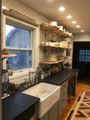 Soapstone was tastefully selected for this rustic kitchen.