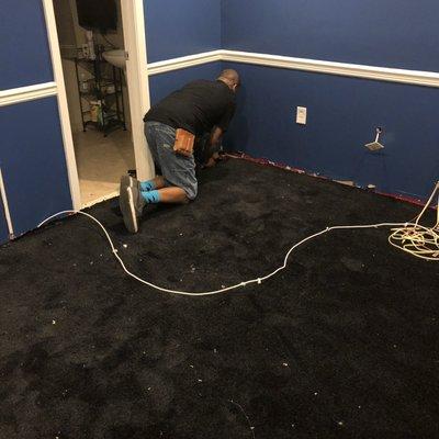 Stretching (installing) carpet .