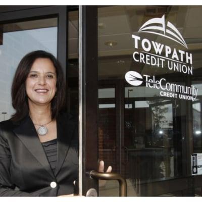 Rose Bartolomucci, president and CEO of Towpath Credit Union stands at the entrance of the Fairlawn branch.