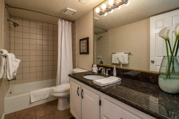 This bathroom connects to the living and dining room area of the nightly rental condo.