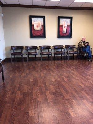 Individual chairs with reading material in waiting room.