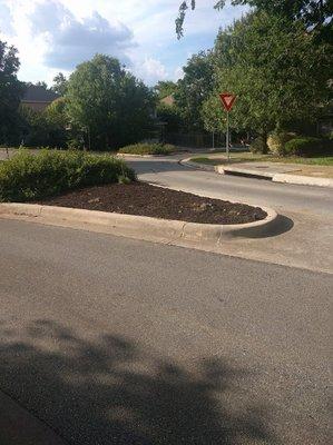 Instead of planting or maintaining plants CAM mulched around a couple of weeds at this intersection.