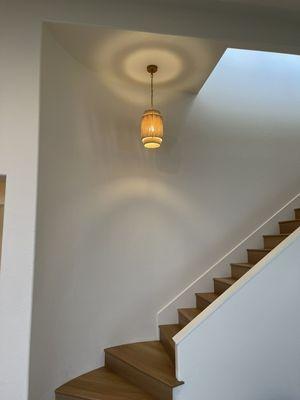 New chandelier installation in staircase