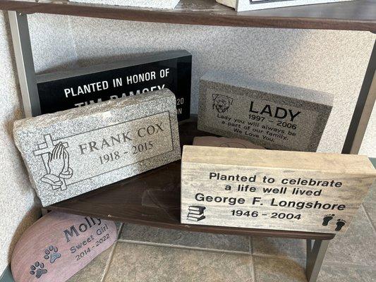 Assortment of granite, limestone, and river rock memorials.