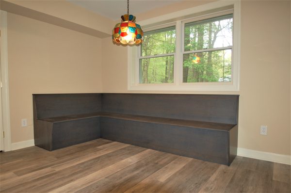 A custom banquette seating area near the summer kitchen.