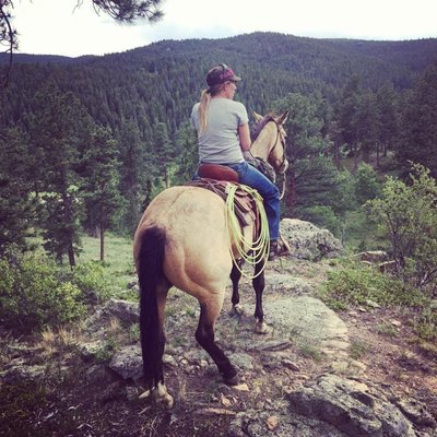 Our Trainer, Brittnee, working with a horse on trail.