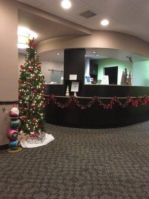 Beautifuly decorated front desk for Christmas. Lovely office.