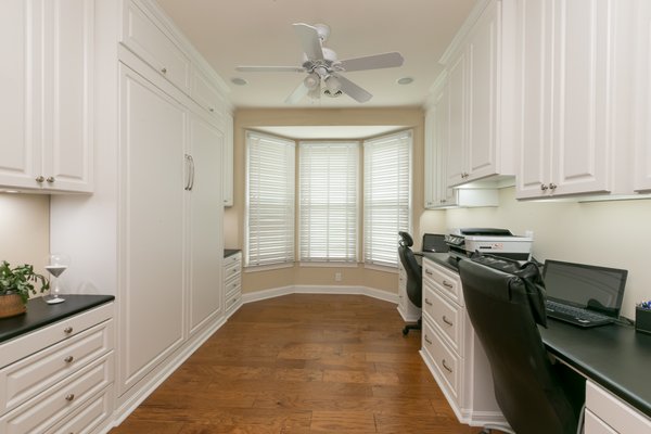 Built-in wall bed and office in white and raised panel.