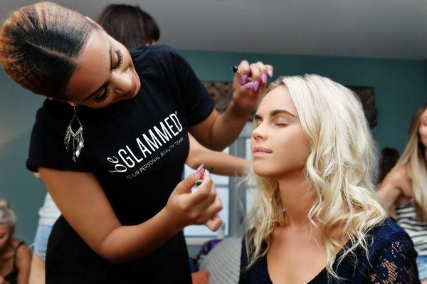 Behind the scenes: beGlammed stylists touching up models during a photoshoot