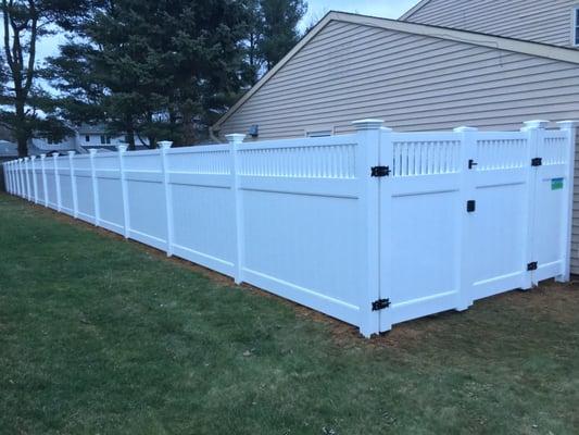 Closed spindle top white vinyl fence.