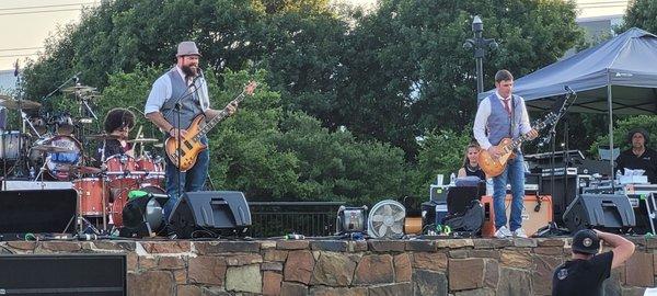 Silent Rumor Band playing 70s rock in the June event for Addison After Dark, in Addison Circle Park.