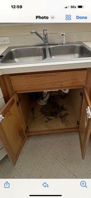 Water damage under cabinet we said needed repair and Delgados said lower cabinet needed to be replaced,  they left it looking  like this.