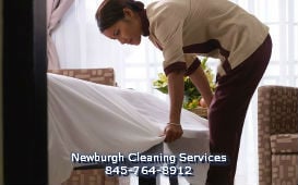 maid and house cleaning service from Newburgh Cleaning Services (845) 764-8912 cleaning the bedroom and tidying the living area