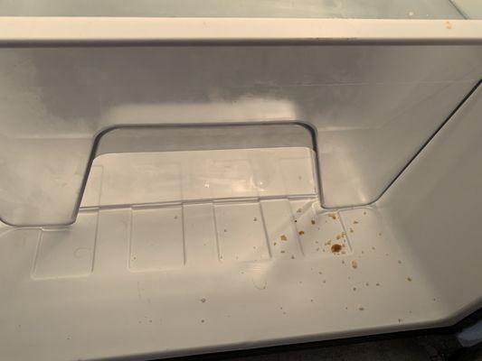 Uncleaned fridge with lingering smell, crumbs, hair in fridge