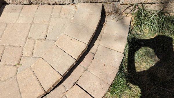 The entire lower step is loose and the stones are coming apart.  There is also a growing gap between the steps and retaining wall.